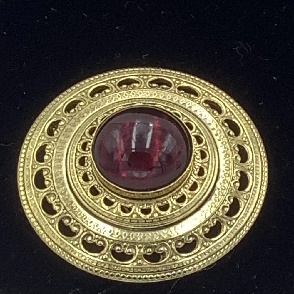 Gold Tone Round Filigree Brooch with Red/Purple Stone